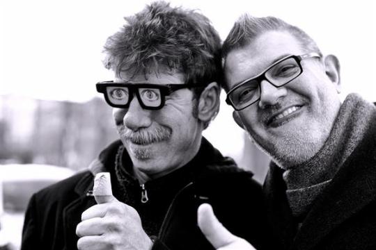 Two guys giving their thumbs up