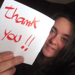 girl holding thank you sign