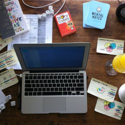 Table With Laptop and Covered With Creative Tools