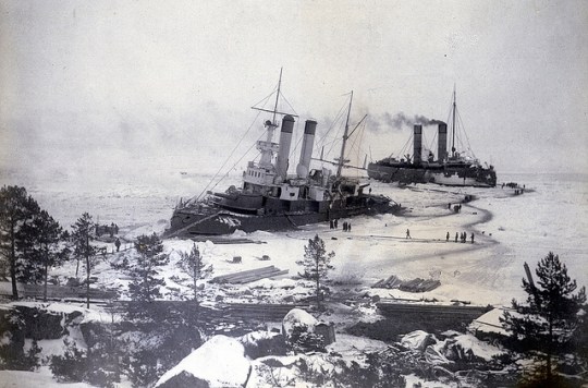 Old photo of two ice breakers near shore