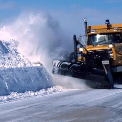 snowplow pushing snow down a street
